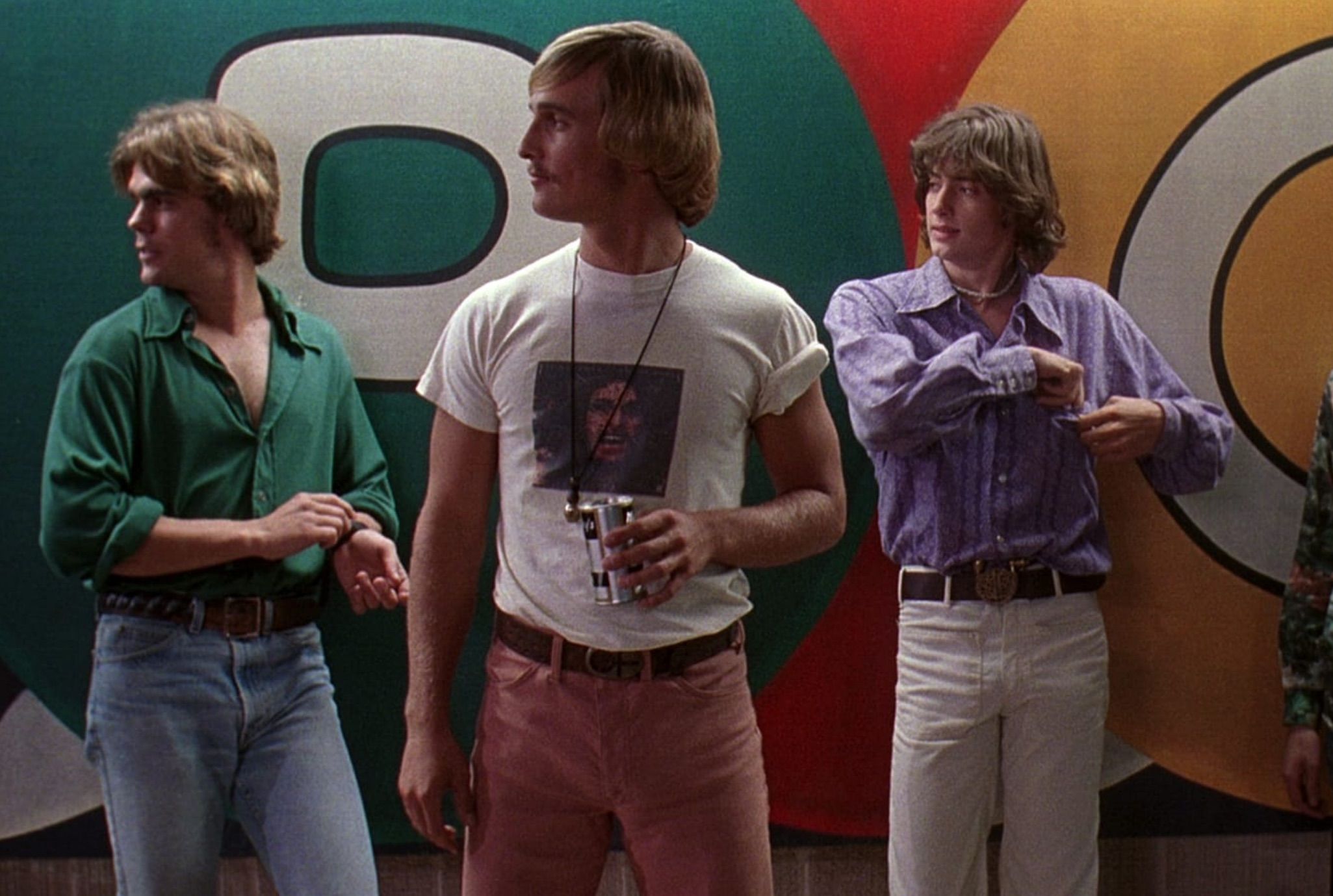 three white men stand in front a wall; Dazed and Confused