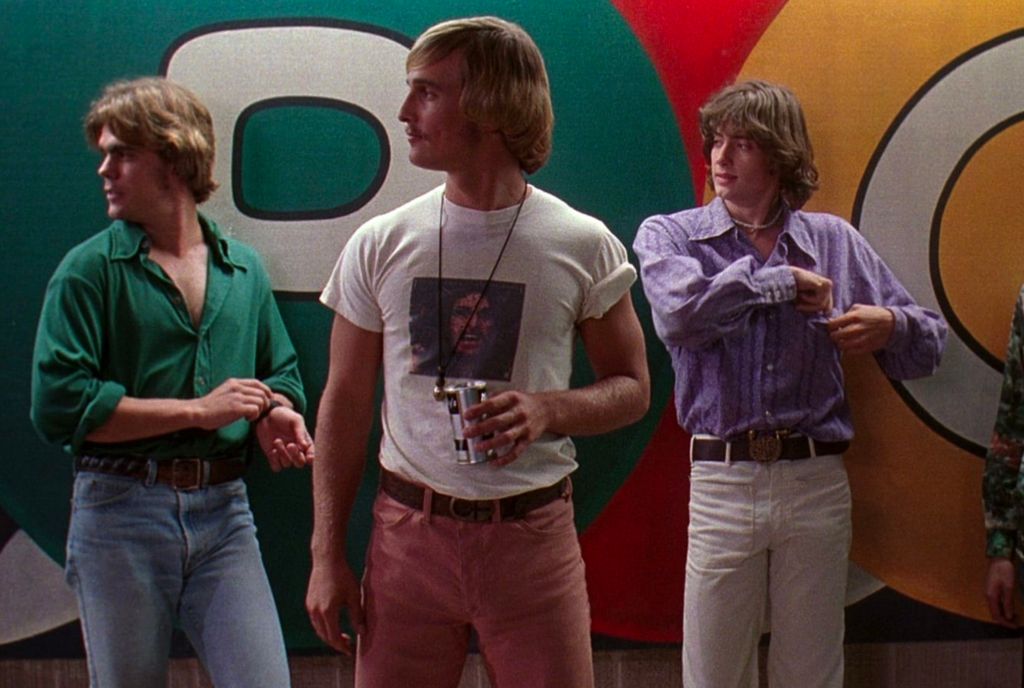 three white men stand in front of a wall; Dazed and Confused