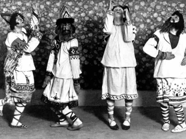 four dancers in traditional eastern European dress perform Stravinsky's The Rite of Spring