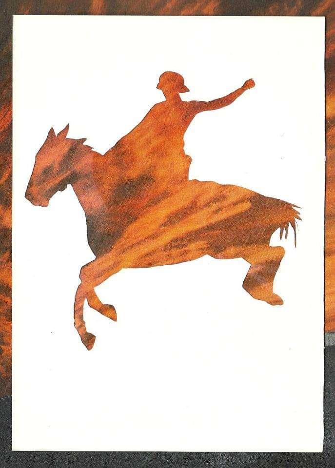 silhouette of woman on horse against bright orange sunset