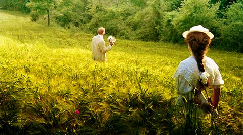 two people in white clothes stand in a green field of barley; Julian Sands and Helena Bonham-Carter in A Room With a View
