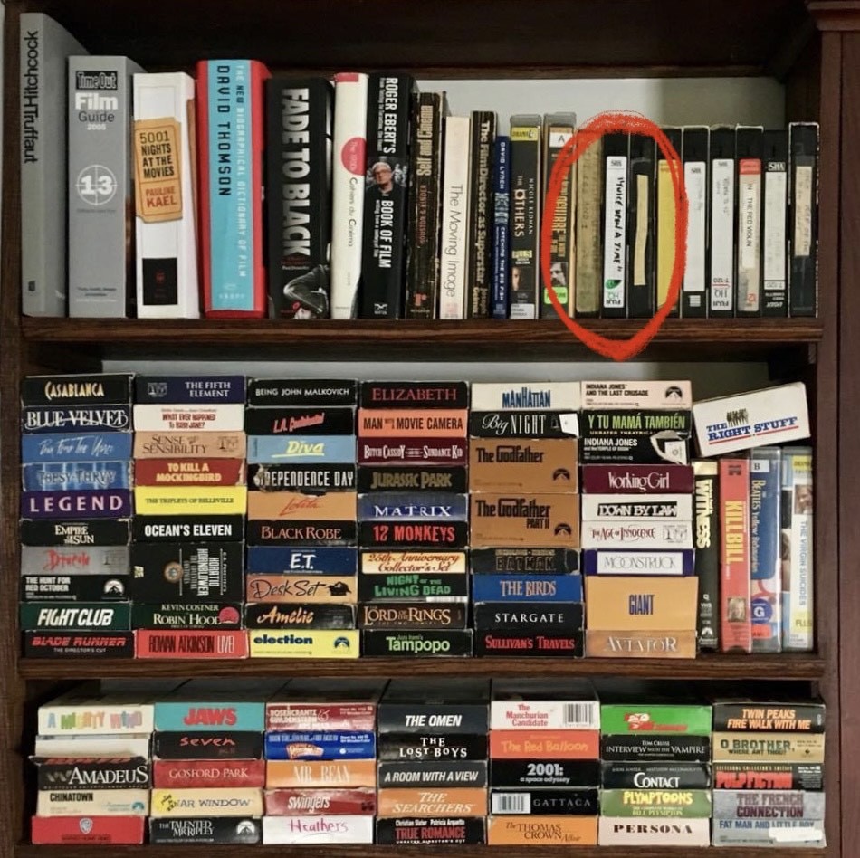 shelves lined with stacks of VHS tapes