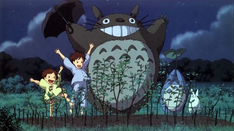two girls and three forest spirits smile in front of a garden; Miyazaki's Totoro