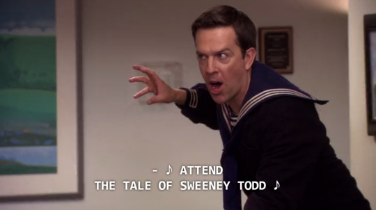 a white man wearing a sailor shirt sings in an office setting; Ed Helms as Andy Bernard in The Office